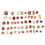 A group of Roman and possibly earlier ancient jewellery beads including numerous carnelian