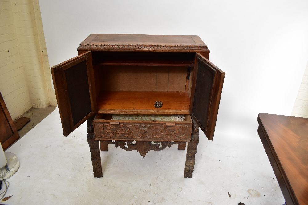 A late 19th century carved oak Black Forest-style side cabinet, the twin doors decorated with - Image 3 of 4