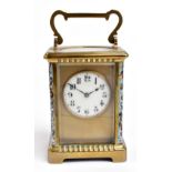 A 19th century brass cased carriage clock with champlevé enamel corner columns flanking the