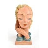 A 1950s painted terracotta bust in the Goldschneider-style depicting a maiden with blonde hair,