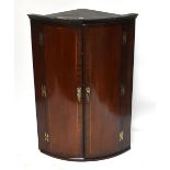 A Georgian inlaid mahogany bowfronted corner cupboard, with H-shape hinges, height 102cm, diameter