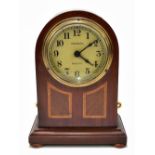 PULSYNETIC; an Edwardian mahogany and inlaid dome topped mantel clock, the circular dial set with