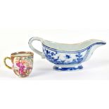 A Chinese blue and white sauce boat decorated with internal floral spray and landscape to the