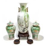 An early 20th century Chinese Famille Verte twin handed floor vase decorated with stylised birds and
