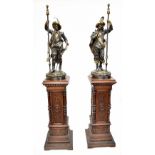 A large and impressive pair of late 19th century bronzed mixed-metal lamps modelled as Cavaliers,