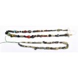 Two ancient bead necklaces including iridescent and coloured glass, carved stone and faience