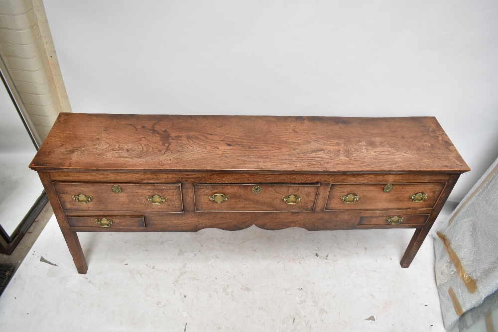 A George III oak and elm dresser base, the moulded rectangular top above three drawers with two - Image 2 of 6