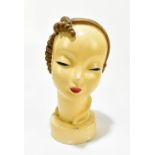 A 1950s painted plaster bust in the Goldschneider-style depicting a maiden with gilt hair, raised on