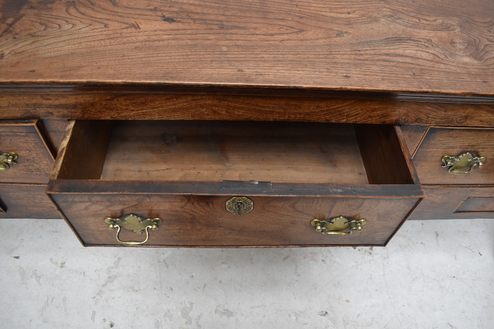 A George III oak and elm dresser base, the moulded rectangular top above three drawers with two - Image 6 of 6