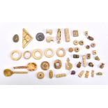 A group of Roman carved bone items including two spoons, whorls/rings, trinkets, pinheads, beads,