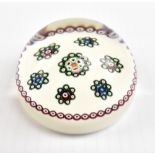 WILLIAM MANSON; a glass paperweight decorated with scattered canes, signed and dated 2002,
