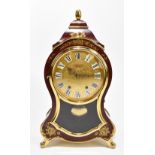ELUXA; a Swiss shaped mantel clock with boulle-effect finish and gilt metal mounts, the signed