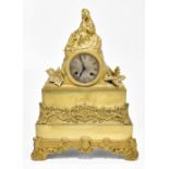 A 19th century French gilt brass mantel clock with surmount modelled as a lady holding a book