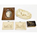 A small white marble carving of a sleeping child, length 8.5cm, two relief plaques, a printed