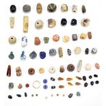 A group of ancient jewellery beads including ceramic and glass examples, one bead with millefiori-