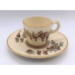 KINKOZAN; a Japanese Meiji period Satsuma cup and saucer decorated with a procession and with