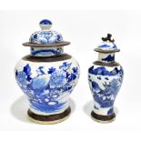 Two Chinese blue and white crackle glazed temple jars and covers, the larger example decorated