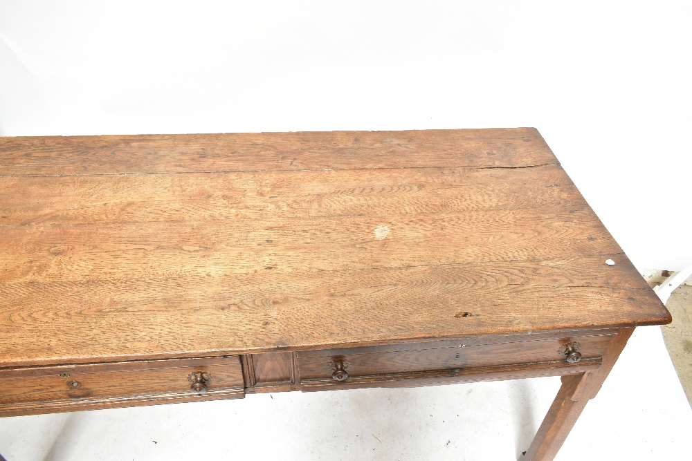 A late 19th century French oak two drawer writing table raised on chamfered square sectioned - Image 2 of 4