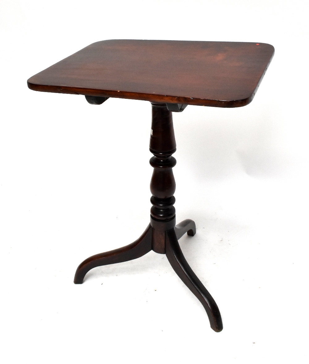 A George III oak tilt-top tripod occasional table with three-piece top above turned central column
