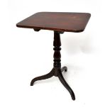 A George III oak tilt-top tripod occasional table with three-piece top above turned central column
