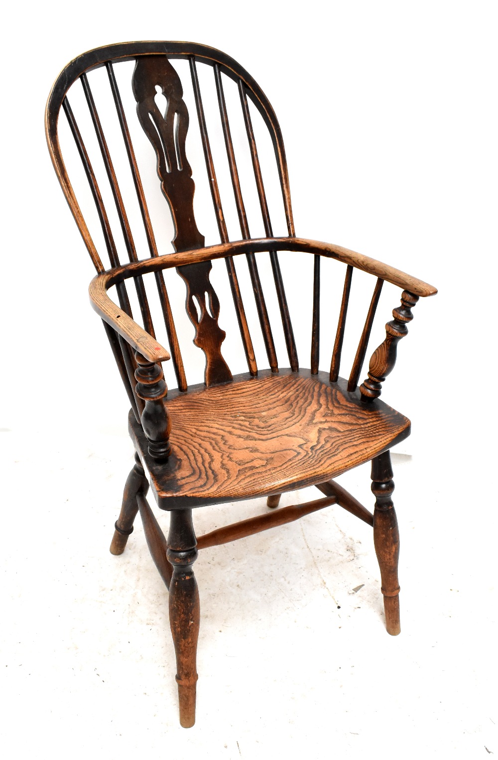 A mid-19th century ash and elm high hoop back Windsor-type elbow chair.Additional InformationThere