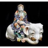 A Japanese Meiji period Satsuma figure seated upon an elephant and holding a scroll, unsigned,