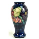 WALTER MOORCROFT; a vase decorated in the 'Clematis' pattern on a blue ground, with blue signature