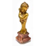 BECKER; an Art Nouveau bronze figure of a girl clutching her doll, wearing a floral dress, raised on