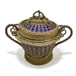 A late 19th century Continental white metal twin handled lidded bowl with internal blue glass liner,