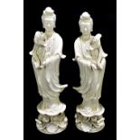 Two 20th century Chinese blanc de Chine models of Guanyin, each with indistinct red mark to base,