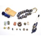 A group of ancient jewellery beads of varied size and form including a part necklace of blue beads