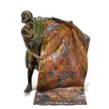 IN THE MANNER OF BERGMAN; a 20th century bronze figure depicting a rug seller, unsigned, height