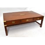 A campaign-style brass bound three drawer coffee table, height 48cm, width 137.5cm, depth 83.5cm.