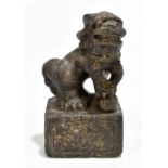 A Chinese carved stone shishi on scroll decorated base, height 18.5cm.Additional InformationSome