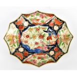 A late 19th century Japanese Imari shaped shallow bowl with iron red, blue, green and gilt