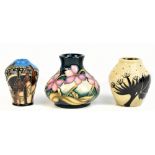 MOORCROFT; three miniature vases to include an example decorated with 'Bottle Kiln' pattern and