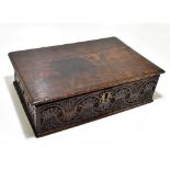 An 18th century oak Bible box with carved decoration to the front and side panels, length 50cm,