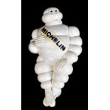 An original French advertising seated figure of Mr Bibendum 'Michelin Man', length 46cm.Additional