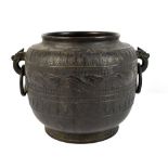 A Chinese bronze jardinière with twin ring handles and bands of lotus leaf decoration, unmarked,