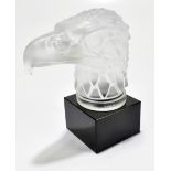 A Czechoslovakian frosted glass car mascot in the Art Deco style, modelled as an eagle's head,