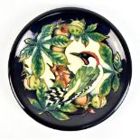 PHILLIP GIBSON FOR MOORCROFT; a circular plate decorated in 'Inglewood' pattern, impressed marks and