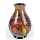 ***WITHDRAWN*** WALTER MOORCROFT; a baluster vase decorated in the 'Orchid' pattern on a flambé