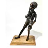 An early 20th century European cast bronze figure of an African boy in the Benin style, raised on