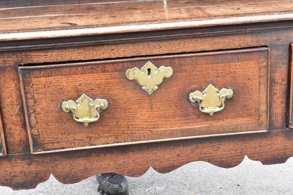 An 18th century oak dresser of low proportions, the plate rack back with carved and moulded - Image 3 of 6