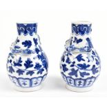 A small pair of 19th century Chinese porcelain vases painted in underglaze blue with floral sprays