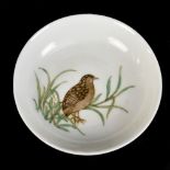 A Chinese porcelain footed dish, painted with a partridge in naturalistic landscape, blue painted