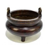 A Chinese bronze censer of squat circular form with rope twist handles above six character signature