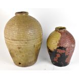 Two ancient Chinese earthenware jars (guan), possibly Song dynasty, both with textured detail to the