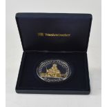 A 2010 'Restoration of the Monarchy' 5oz, £10 silver coin with gold plated embellishment.