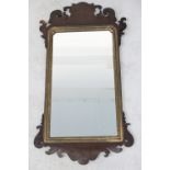 A 19th century mahogany fretwork and gilded wall hanging mirror, length 94cm (af).